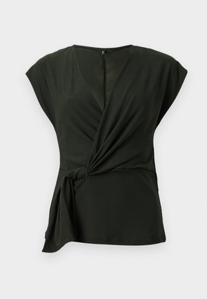 Haut enveloppant vert foncé en tissu doux, avec un décolleté en V et des manches courtes, comprenant un détail noué sur le côté et une fermeture éclair dissimulée au dos.