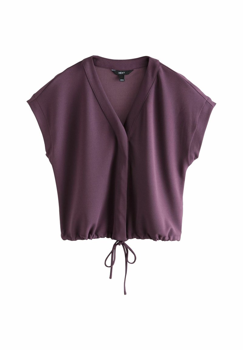 Vínová halenka s překládaným designem, krátkými rukávy a zavazováním v pase. Vyrobená z hladké látky, s volným střihem a hlubokým výstřihem do V.