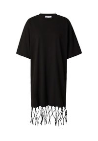 Schwarzes, oversize T-Shirt aus Baumwolle. Verfügt über einen Saum mit geknoteten Fransen. Kurze Ärmel, Rundhalsausschnitt, lockere Passform.