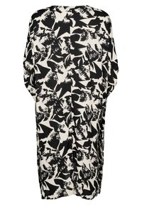 Svart och vit mönstrad kimono med ett abstrakt mönster, avslappnad passform och vida ärmar, tillverkad av lättviktsmaterial.