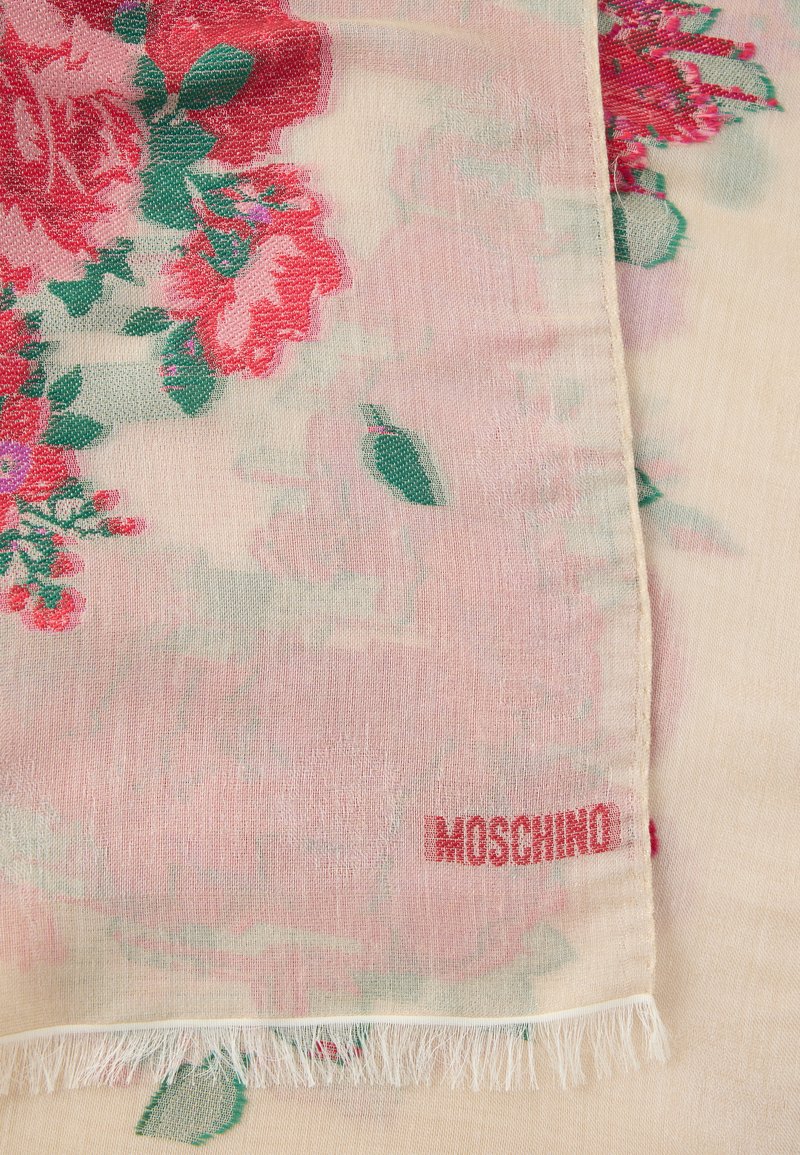 Floral Moschino scarf in soft, sheer fabric; features pink and green roses, subtle pastel background, and fringe edges. Logo embroidered in red.