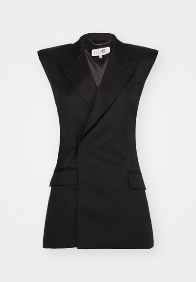 Black tailored vest with sharp lapels, no sleeves, structured shape, and two front pockets. Smooth, textured fabric.
