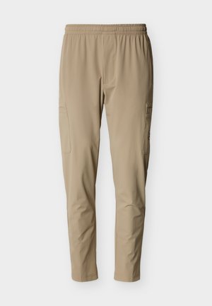 Pantalon cargo beige avec taille élastique, doté de poches latérales et d'un tissu lisse et léger. Coupe fuselée avec des lignes épurées.