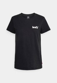 Camiseta de algodón negra con cuello redondo, mangas cortas y un logo blanco de Levi's en el lado izquierdo del pecho. Textura suave, ajuste estándar.