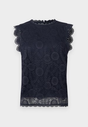 Μπλε ναυτικό αμάνικο τοπ από δαντέλα με λουλουδένια σχέδια, κυματιστές άκρες στα μανίκια και στο τελείωμα, και μικρό φερμουάρ στην πλάτη.