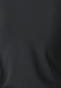 Black cotton fabric with a smooth texture; features slight draping. No visible patterns or hardware details.