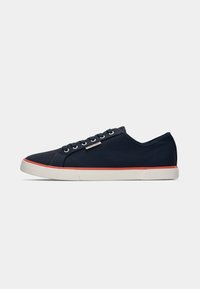 Navy canvas sneakers with a white rubber sole and a red accent stripe, featuring six eyelets and a textured finish.