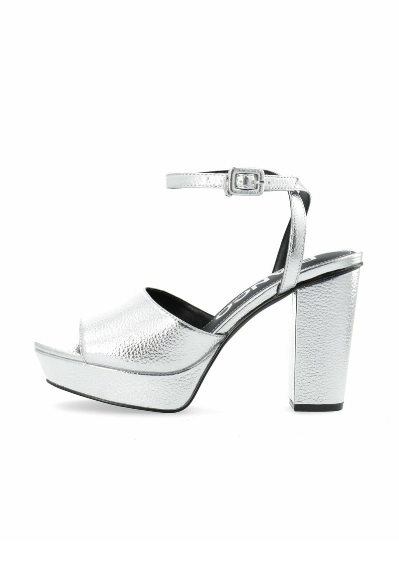 Zilveren platform sandalen met een gestructureerde afwerking, voorzien van een brede band en een enkelsluiting. De chunky blokhak biedt hoogte en stabiliteit.