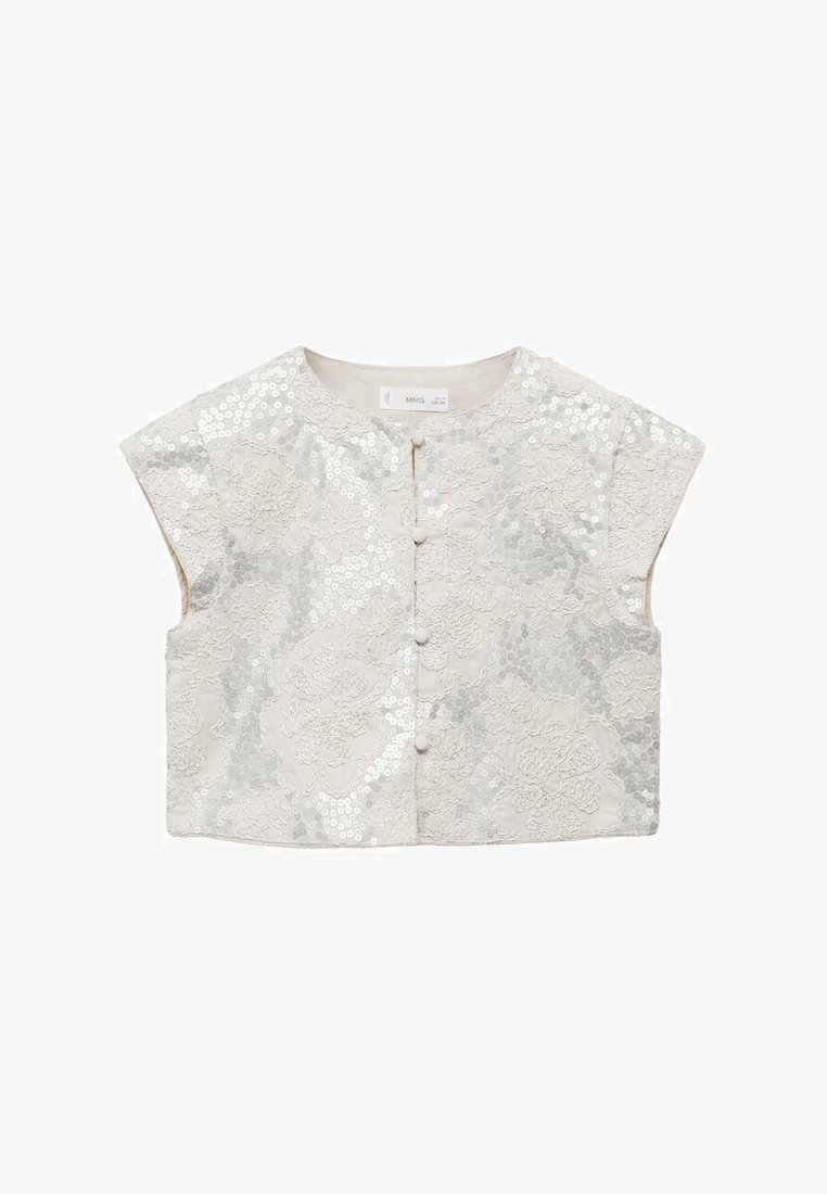 Kort, croppad jacka i ljus beige med blommig spetsdesign, prydd med silverfärgade paljetter och fem knappstängningar på framsidan.