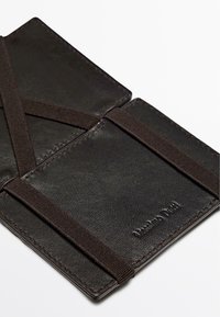 Black leather cardholder with elastic bands, featuring a smooth texture and stitched details. Includes two card slots and embossed branding.