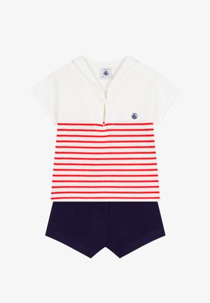 Completo in cotone con maniche corte composto da una maglietta bianca a righe orizzontali rosse e pantaloncini blu navy. Include un bottone e un logo a forma di barca a vela.