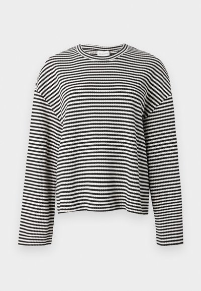 Μακρυμάνικη κοντή μπλούζα με ασπρόμαυρες ρίγες, στρογγυλή λαιμόκοψη, άνετη εφαρμογή και υφασμένο υφή. Κοντό μήκος.