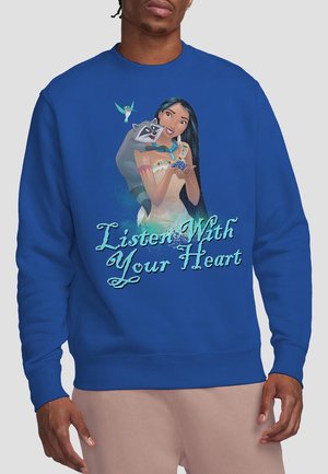Royal blue sweatshirt featuring a character illustration with a raccoon, "Listen With Your Heart" text in a flowing white font. Soft fabric texture.