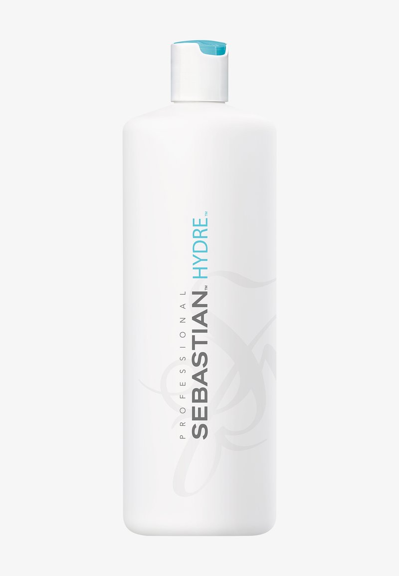 Bouteille cylindrique blanche avec un bouchon à clapet bleu, étiquetée « Sebastian Professional Hydre », produit capillaire.