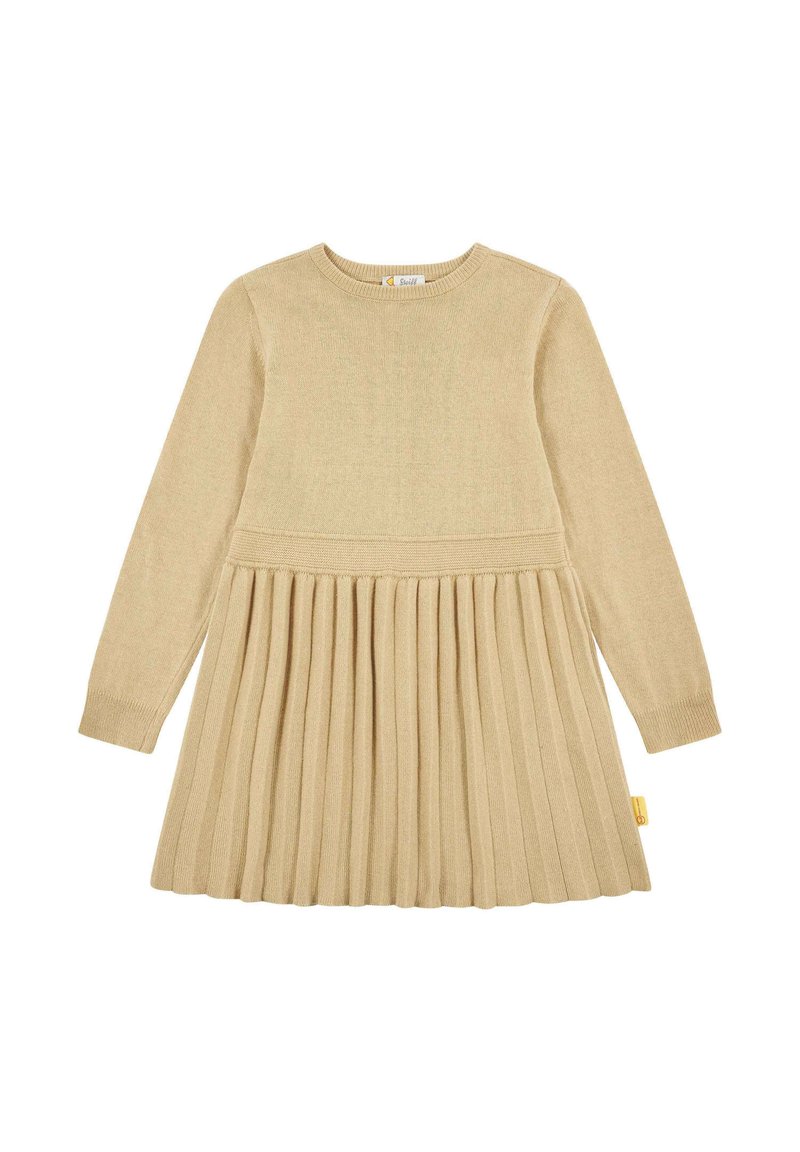 Beige pletené šaty s dlouhými rukávy, žebrovaným korpusem a skládáním sukně. Na boku je žlutá visačka. Měkká textura a přiléhavý design.