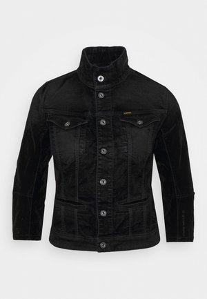 Black velvet jacket with high collar, button front, two chest flap pockets, and side pockets, tailored fit with G-Star Raw branding on sleeve.