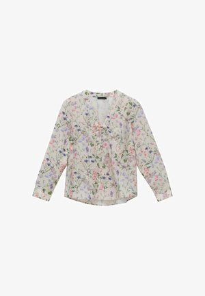 Blouse légère avec un motif floral en rose, violet et vert sur un fond beige. Elle possède des manches longues et un décolleté en V.