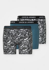 Tre paia di boxer JACK & JONES: neri con stampa di teschi e palme, teal e neri con grafiche bianche a fantasia. Ampie cinture nere.