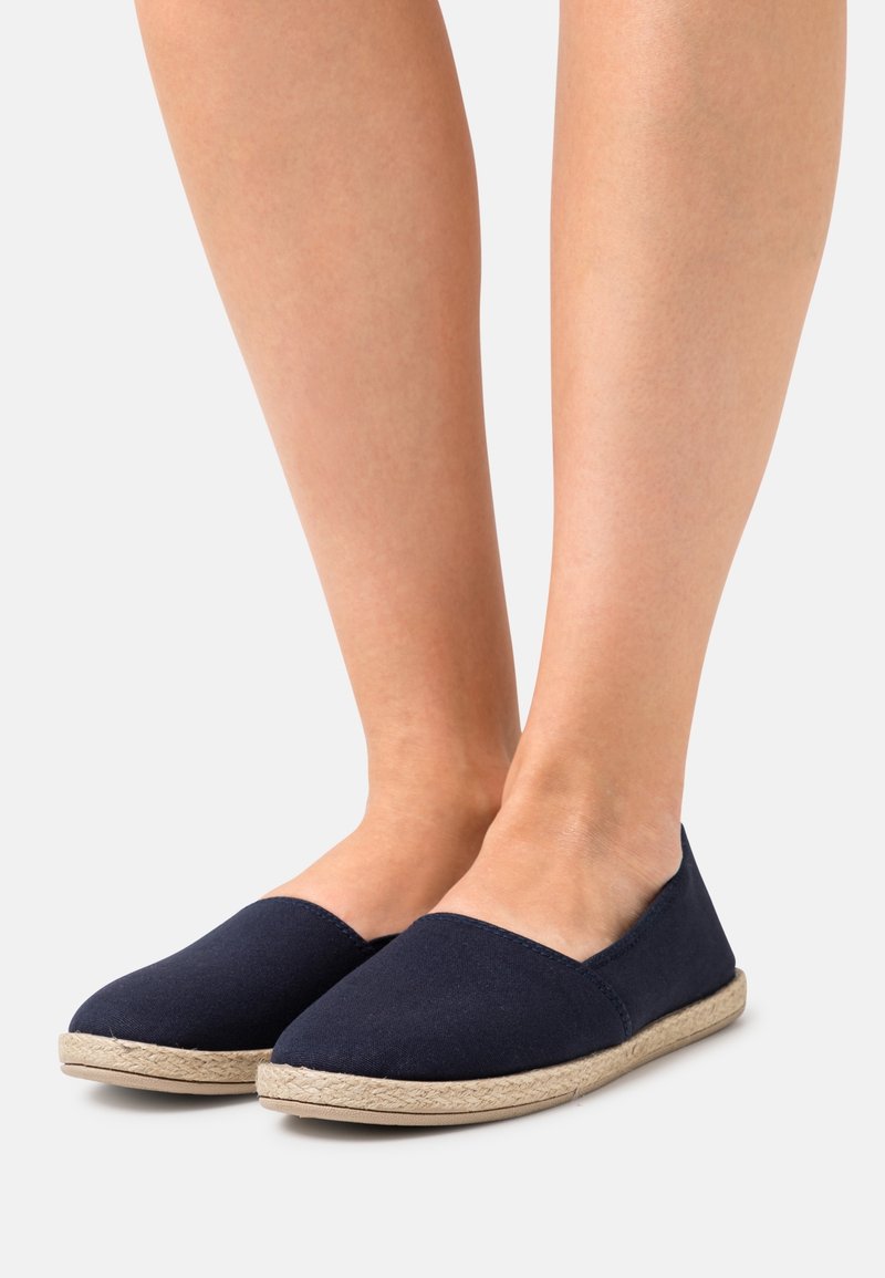 Navy blue canvas espadrilles with a rounded toe and jute sole. Seamless design and soft texture suitable for casual wear.