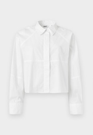 White cropped shirt made from a smooth fabric, featuring a classic collar, long sleeves, and subtle seam detailing. Logo "DAY" at the collar.