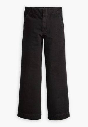 Pantalons en coton noir avec une coupe évasée, dotés d'une ceinture élastique, de poches avant et de ourlets aux chevilles.