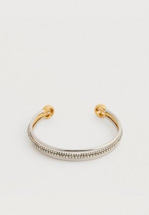 Open cuff bracelet with gold ends, silver band, and a row of small, clear rhinestones along the top, displayed on a white background.