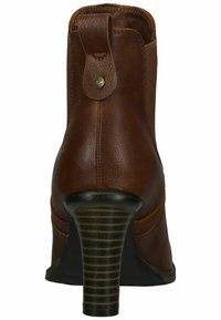 Bottine en cuir marron avec un talon empilé haut, présentant un dos texturé, des coutures décoratives et un bouton ornemental en haut.