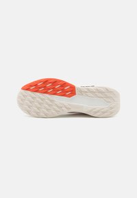 Shoe sole with textured pattern; predominantly white with orange accents. Features diamond-shaped treads for enhanced grip and durability.