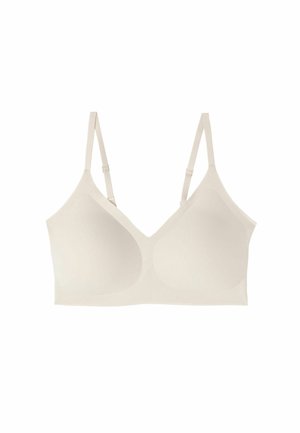 Beige naadloze beha met verstelbare banden, gladde stof en gevormde cups. Ontworpen met minimale hardware en een eenvoudige, puristische vorm.