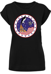 Black t-shirt with a round graphic featuring a rocket, satellite, and American flag motifs in vibrant colors, set against a blue background.
