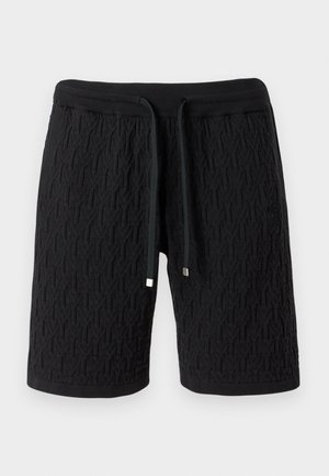 Shorts en maille noire avec motif texturé, taille élastique et cordon avec embouts métalliques.