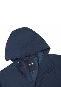 Dunkelblaue Kapuzenjacke mit Reißverschluss und Klettverschlüssen, mit strukturierter Außenseite und glattem Futter. Das Innenetikett zeigt die Größe an.