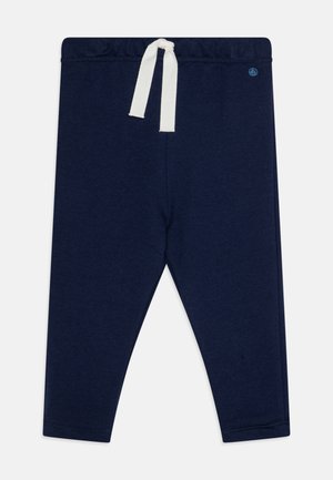 Leggings di colore blu navy realizzati in tessuto morbido, dotati di una vita elastica con un cordino bianco. Nessun motivo o accentuazione visibile.