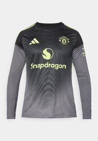 Langärmliges Sporttrikot in Schwarz und Dunkelgrau mit gelben Akzenten. Mit Manchester United-Logo und dem Text "Snapdragon". Texturiertes Musterdesign.