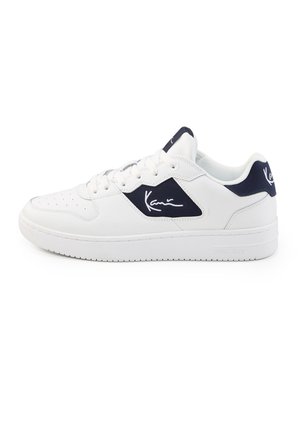 White low-top sneaker with navy accents and signature logo on side and heel, perforated toe, and lace-up closure.