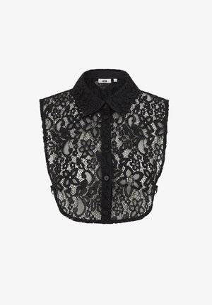 Juodas nėrinių trumpas viršus su apykakle, užsegamas mygtukais ir gėlių raštais. Permatoma medžiaga su banguoto apvado apdaila.