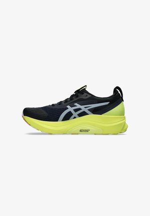 Black running shoe with a textured upper, reflective silver accents, and a neon yellow sole featuring a 4D Guidance System.
