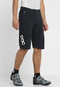Black cycling shorts with zippered pockets, featuring a 'POC' logo in white on the side. Made from lightweight, breathable fabric.