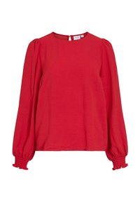 Blusa larga roja de manga larga con cuello redondo, tela texturizada y mangas abullonadas. Los puños presentan detalles fruncidos y un cierre en forma de ojal en la parte posterior.