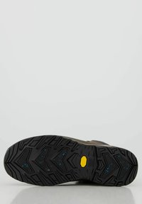 Zwarte rubberen buitenzool met gestructureerd loopvlak; gele Vibram-logo zichtbaar. Bovenmateriaal in een gedempte kleur met minimalistische ontwerpelementen.