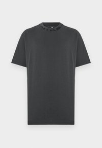 Camiseta negra de manga corta hecha de algodón, con un cuello redondo y el logo "NIKE" grabado en el collar. Sin patrones ni acentos adicionales.