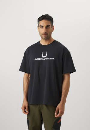 Black oversized t-shirt made of cotton, featuring a white "UNDER ARMOUR" logo on the front, crew neck, and short sleeves.