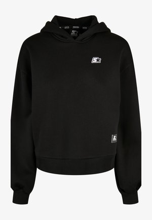 Czarna bluza z kapturem wykonana z mieszanki bawełny. Posiada małe białe logo na piersi oraz ściągacze przy mankietach i dolnej krawędzi zapewniające pewne dopasowanie.