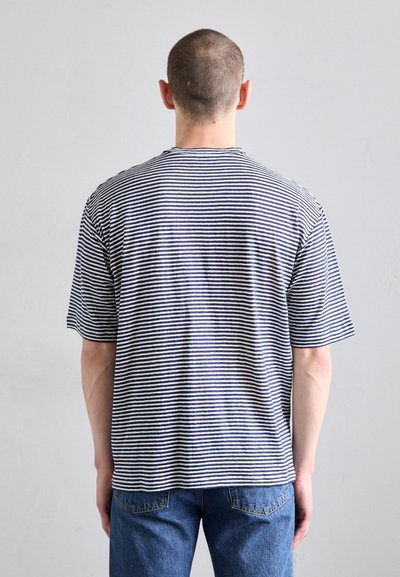 Gestreiftes Baumwoll-T-Shirt in lockerer Passform, mit marineblauen und weißen horizontalen Streifen, kurzen Ärmeln und rundem Ausschnitt.