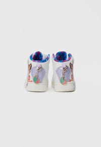 Fehér magas szárú gyerek sneaker, színes mesefigurás nyomatokkal, lila csillámos sarokpanelekkel és csatlakoztatott rózsaszín és türkiz charm kulcstartókkal.
