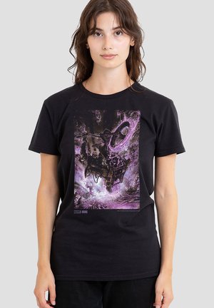Young woman wearing black t-shirt featuring a Marvel comic-style design with a purple glowing portal and a motorbike in action.