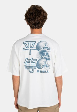 Man wearing white t-shirt with three blue skull illustrations and two large blue Asian characters above the word "REELL" on the back.