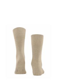 Beżowe skarpetki bawełniane o prążkowanej teksturze, sięgające do połowy łydki, z wzmocnionym piętą. Posiadają gładkie szwy i rozciągliwe otwory dla większego komfortu.