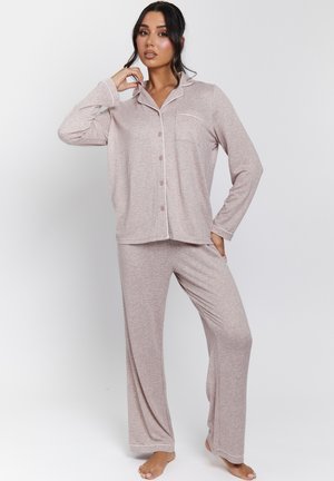 Light pink pajama set with long-sleeve button-up top featuring a chest pocket and contrast trim; loose-fit pants with a straight leg.