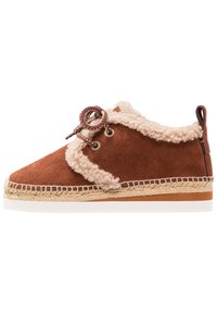 Brown suede sneaker with beige faux fur trim, round laces, and woven jute sole; features a flat white outsole and brown accents on the heel.